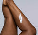 Woman’s legs with swipes of FarmHouse Fresh Harvest Green Shea Butter on them, demonstrating the thick texture of this travel size body moisturizer.