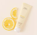 Farmhouse Fresh Hello Yellow, a moisturizing hand cream for dry skin, with a slice of lemon next to it.