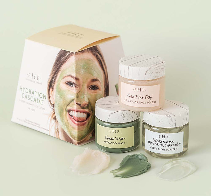 Three jars with skincare products from Hydration Cascade Instant Spa Facial by FarmHouse Fresh with a box next to them. Includes a face polish, hydrating face mask and a face moisturizer.