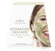 Front view of the box of Hydration Cascade 3-step Instant Spa Facial. Shows a woman with dry skin smiling with avocado mask on her face.