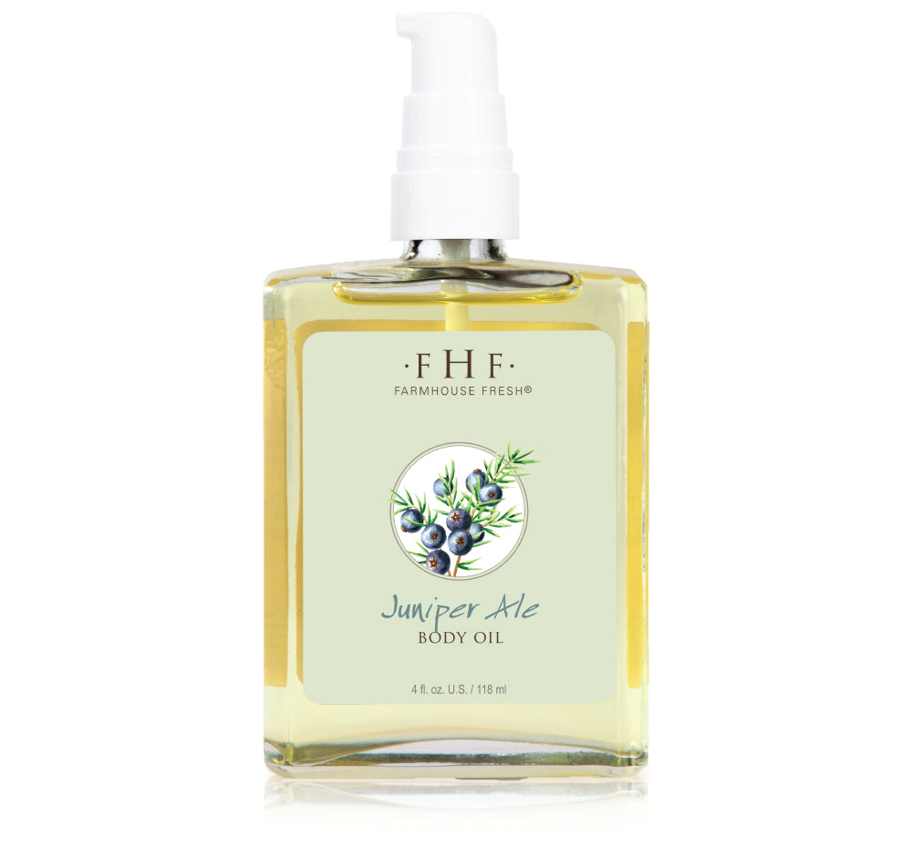 A bottle of Juniper Ale body oil by FarmHouse Fresh infused with natural botanical extracts.