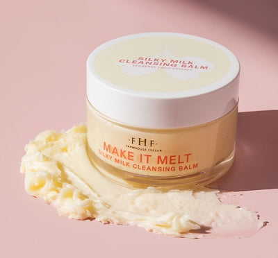A jar and a texture smear of FarmHouse Fresh Make It Melt Silky Milk Cleansing Balm that removes makeup and clears skin.