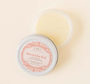 An opened jar of FarmHouse Fresh All-Purpose Shea Butter Balm for dry, chapped skin.