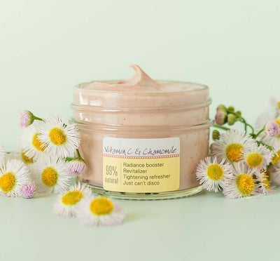 A jar of FarmHouse Fresh Mighty Brighty Vitamin C + Chamomile Brightening Mask for aging and dull skin.