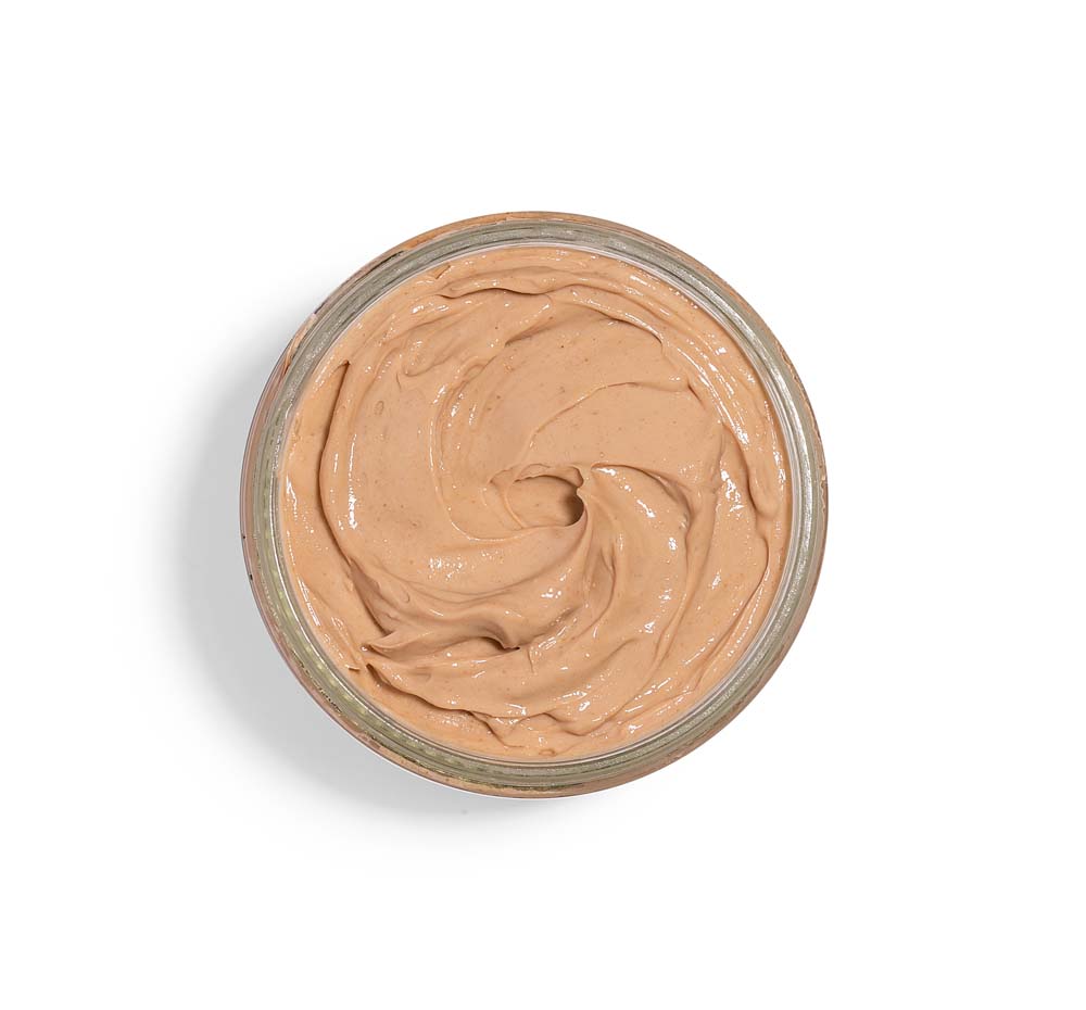 An opened jar of Mighty Tighty Turmeric & Banana Tightening Mask by FarmHouse Fresh made with an antioxidant-rich blend of turmeric, bananas, and locally grown echinacea extract that nourish skin and make it more radiant.