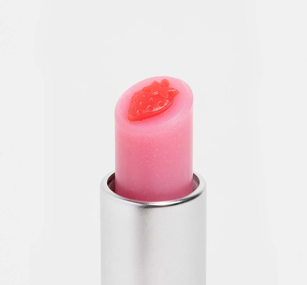 The top of an open tube of FarmHouse Fresh Strawberry Mood Fruit tinted lip balm that nourishes and soothes dry lips.