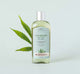 A bottle of FarmHouse Fresh New Groove Gel Cleanser for face next to a hemp leaf.