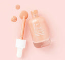 A bottle with a dropper of FarmHouse Fresh Pink Dusk Illuminating Peptide Serum that provides a soft, pinky-peach glow for all skin tones.