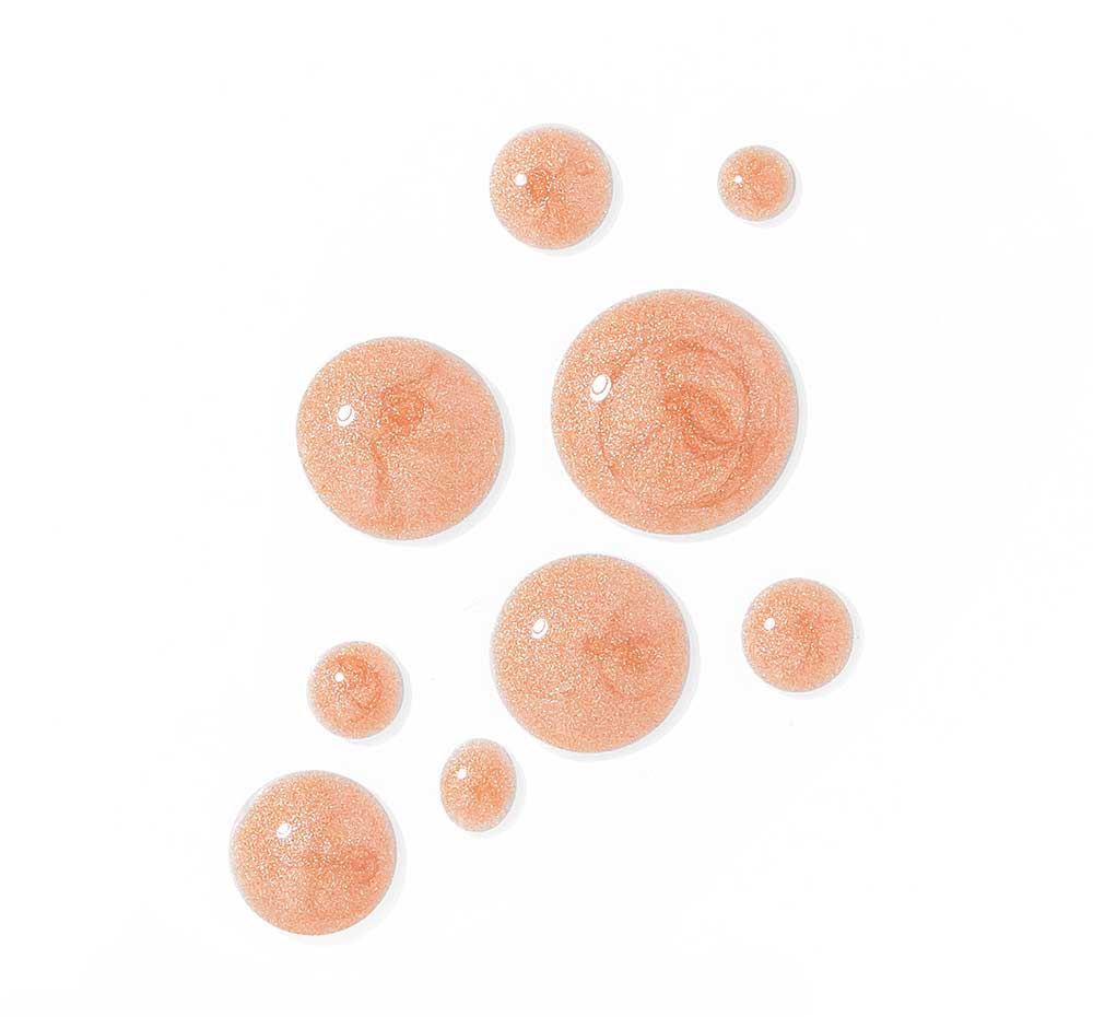 Drops of FarmHouse Fresh Pink Dusk Illuminating Peptide Serum on a white background, demonstrating the lightweight formula with a beautiful sheen.