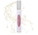 A bottle of Farmhouse Fresh perfume with a splash of water, exuding the long-lasting scent of Pink Moon Travel Spray.