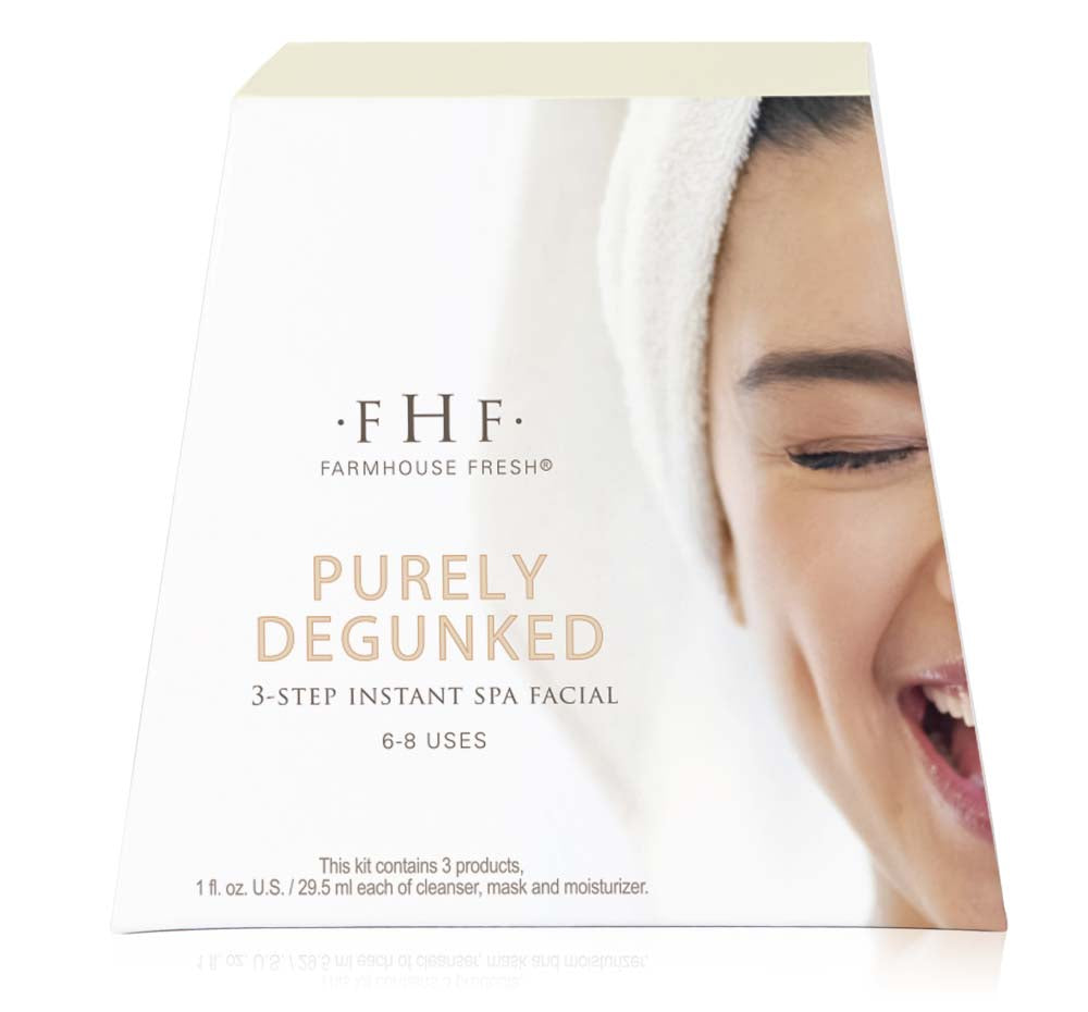 Front view of the box of Purely Degunked 3-step Instant Spa Facial. Shows a smiling woman with a balanced complexion after using all products in this skincare set.