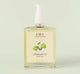 A bottle of FarmHouse Fresh Quinsyberry Botanical Body Oil with a light, unisex apple blossom and tea scent.