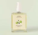 A bottle of FarmHouse Fresh Quinsyberry Botanical Body Oil with a light, unisex apple blossom and tea scent.