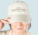 A woman wearing FarmHouse Fresh Donkey Rescuer Club Hat that helps save farm animals.