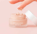 Person’s fingers dipping in a jar of FarmHouse Fresh Stunning Dawn Brightening Eye Cream that instantly hydrates, brightens, corrects & conceals.