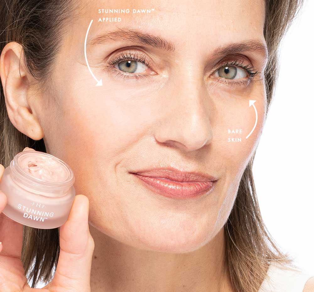 A woman with bare skin on one side of her face and with FarmHouse Fresh Stunning Dawn Brightening Eye Cream under the other eye, showing the visible change in dark circles.