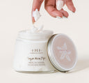 A woman’s hand dipping a finger into a jar of FarmHouse Fresh Sugar Moon Dip Ageless Body Mousse made with age-fighting ingredients like firming peptides & retinol.