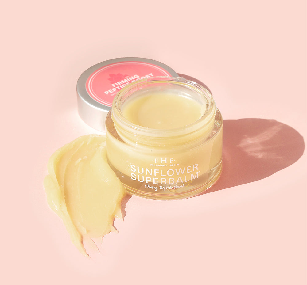 A jar of FarmHouse Fresh Sunflower Superbalm Firming Peptide Boost face balm, featuring its rich, thick texture that replenishes dry, distressed skin.