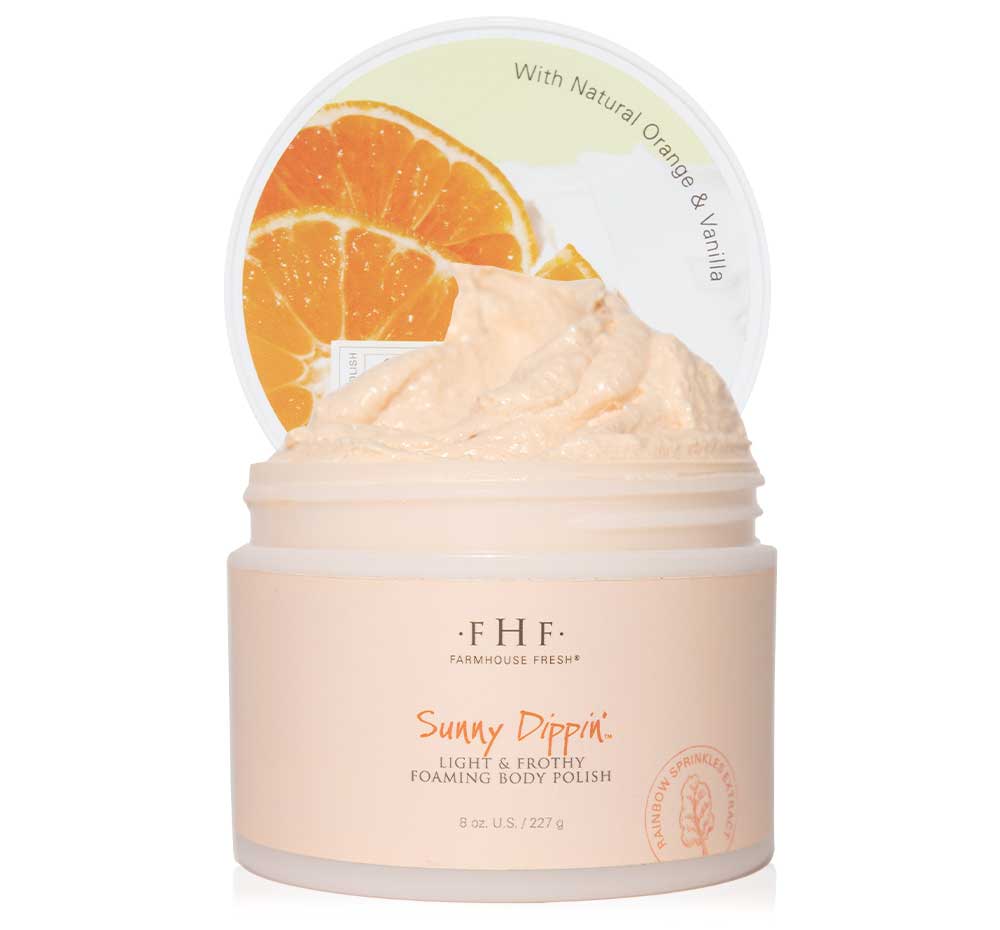 A jar of FarmHouse Fresh Sunny Dippin’ Foaming Body scrub made with nourishing botanical suds blended with jojoba oil, olive seed powder and refreshing notes of natural orange and cream.