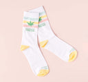 FarmHouse Fresh Total Swellness Socks made with 80% cotton, 15% polyester, 5% spandex on a pink background.
