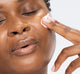 A woman applying Farmhouse Fresh's Watermelonaid serum with CBD to achieve silky-soft skin.