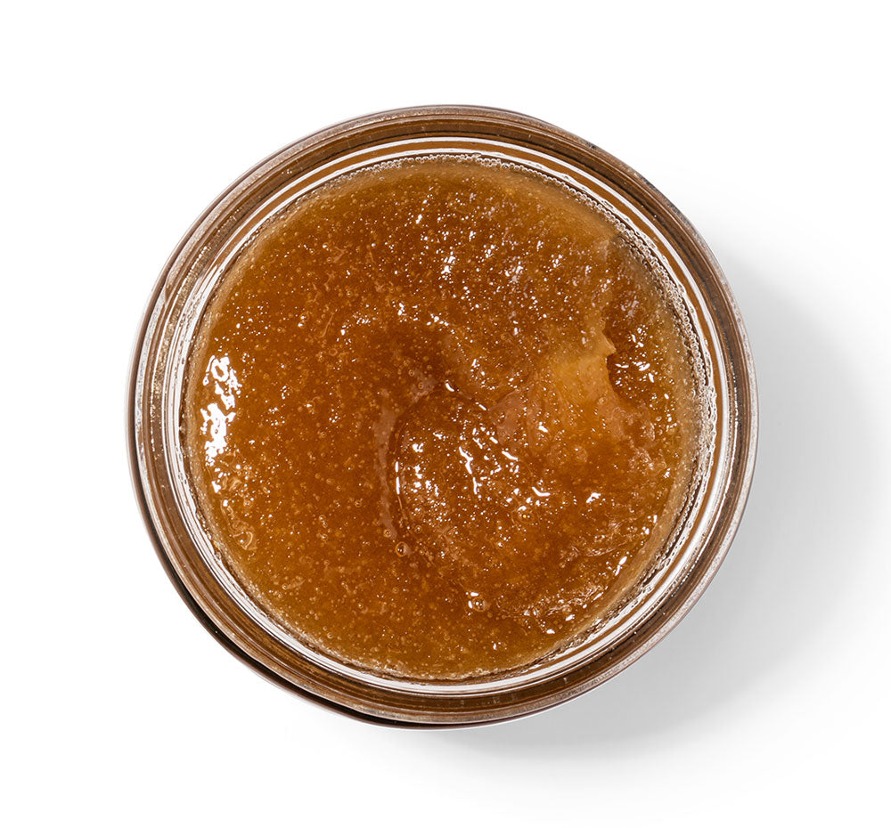 Top view of an open jar of Bourbon Bubbler Liquor Infused Body Polish made with brown sugar.