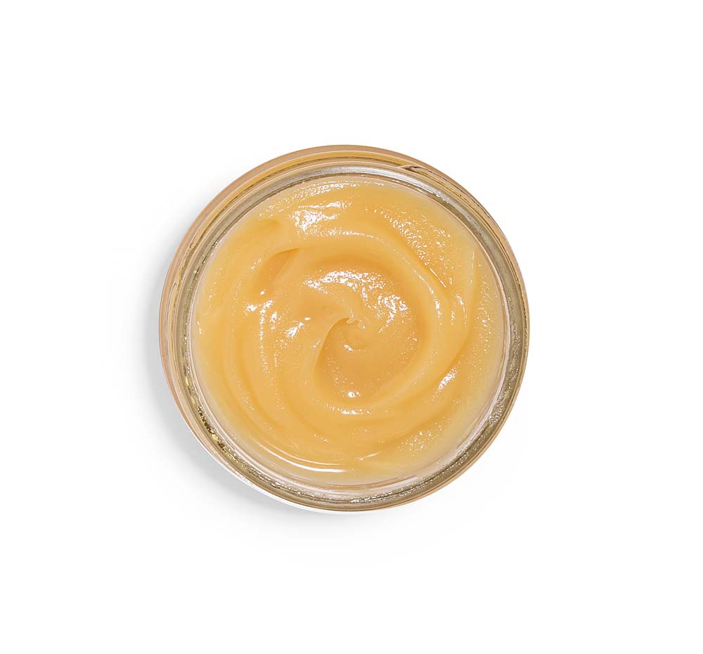 Top view of an opened jar of FarmHouse Fresh’s Organic Sunflower Honey-Butter, an intense hydrator for dry skin.